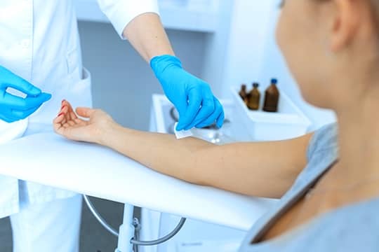 Woman patient having her arm prepared for blood draw